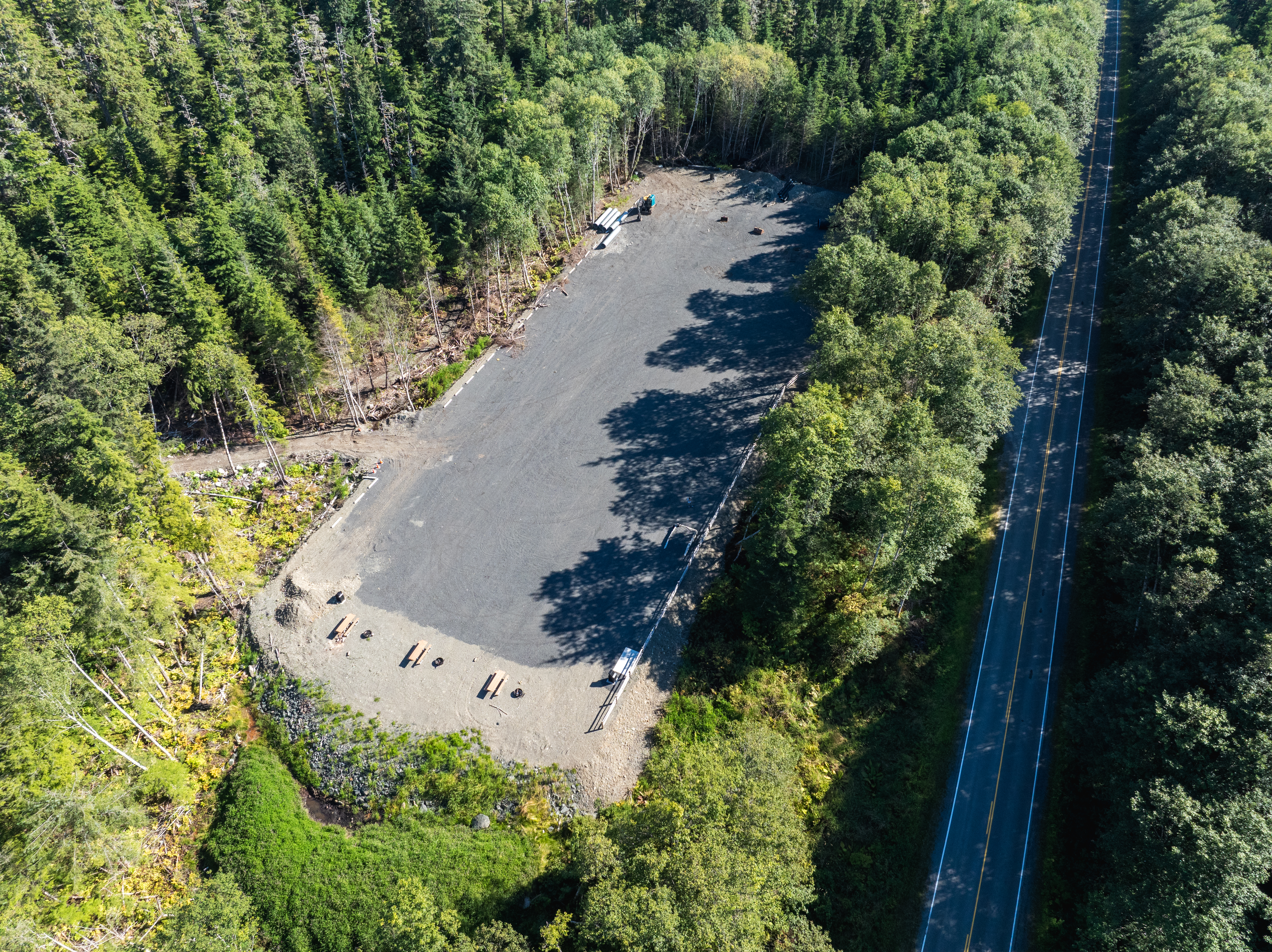 People riding off-road vehicles down a dirt road.