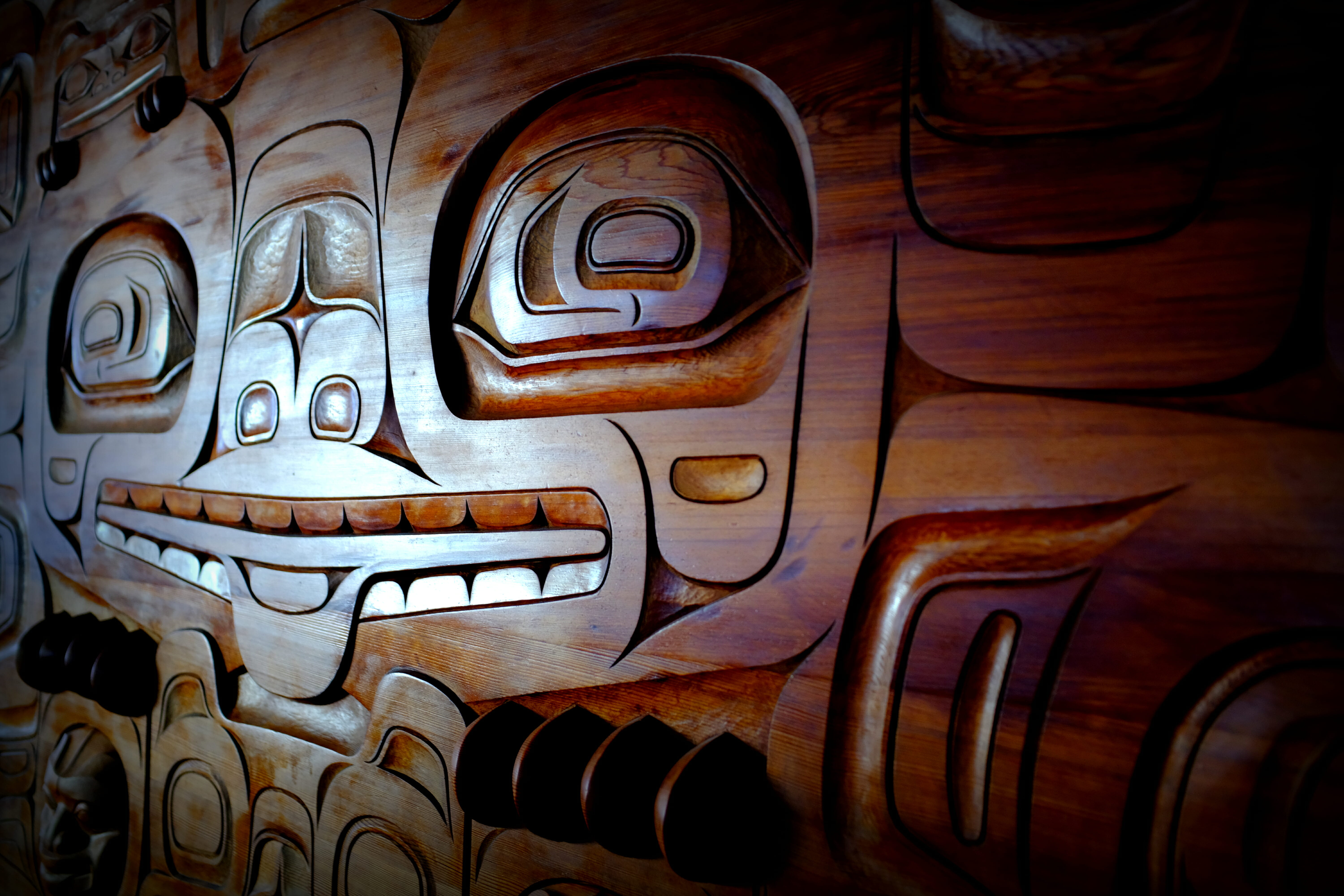 Tlingit Carved Panel behind the circulation desk at the Downtown Library