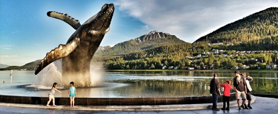 View of whale statue with people around.