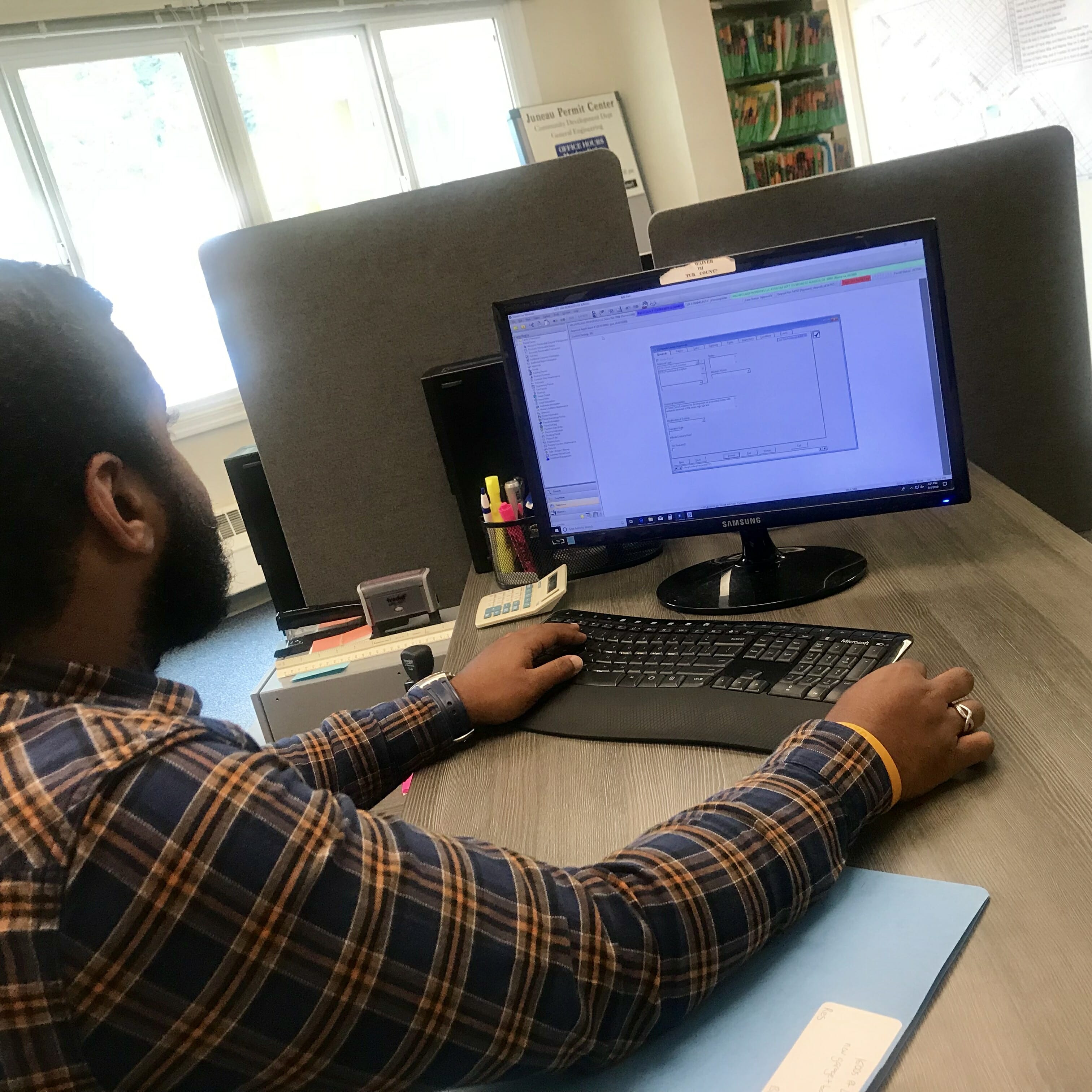 CDD Employee reviewing work on computer.