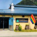 This is an image of the exterior front of Zach Gordon Youth Center where a Pride flag is waving.