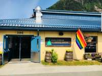 This is an image of the exterior front of Zach Gordon Youth Center where a Pride flag is waving.