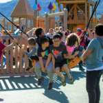 This is an image of a bunch of kids on a large swing at Project Playground.