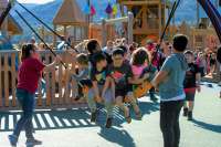 This is an image of a bunch of kids on a large swing at Project Playground.