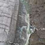 This is an image of the overflowing water from Suicide Basin running along the glacier boundary.