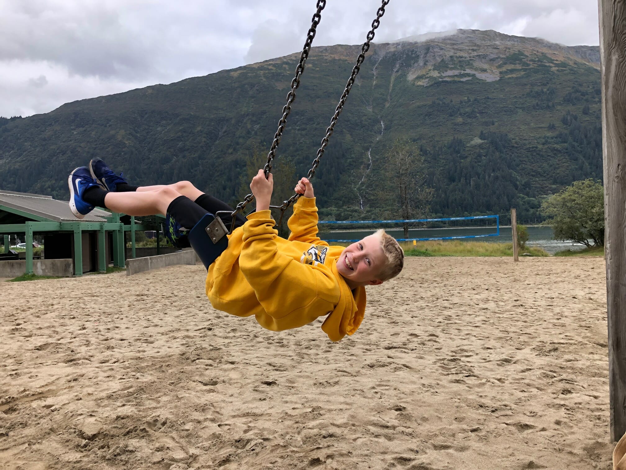 Child playing on swings at Savikko Park