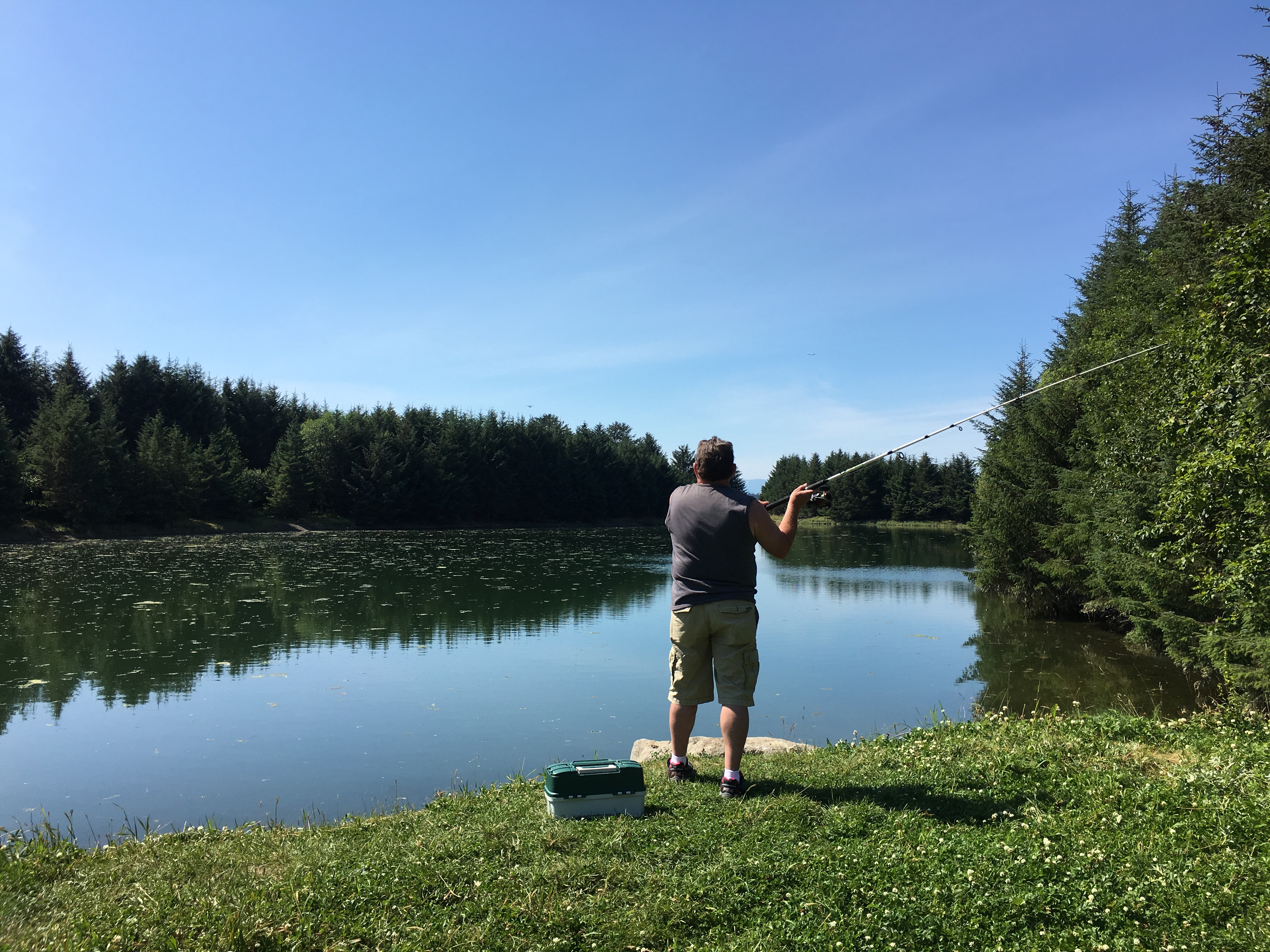 A man fishing at Fish Creek pond.