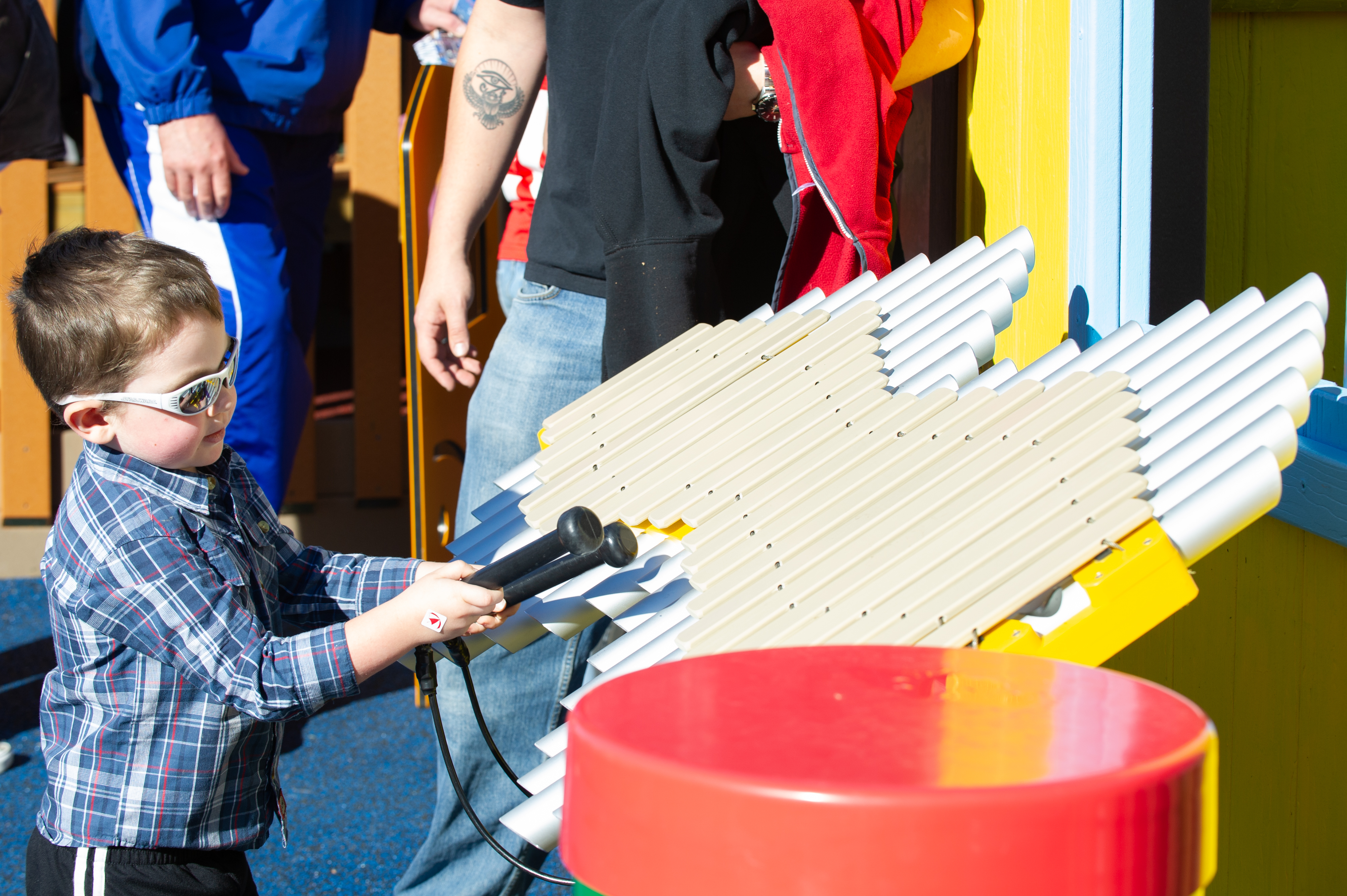 A child plays the musical feature at Project Playground.
