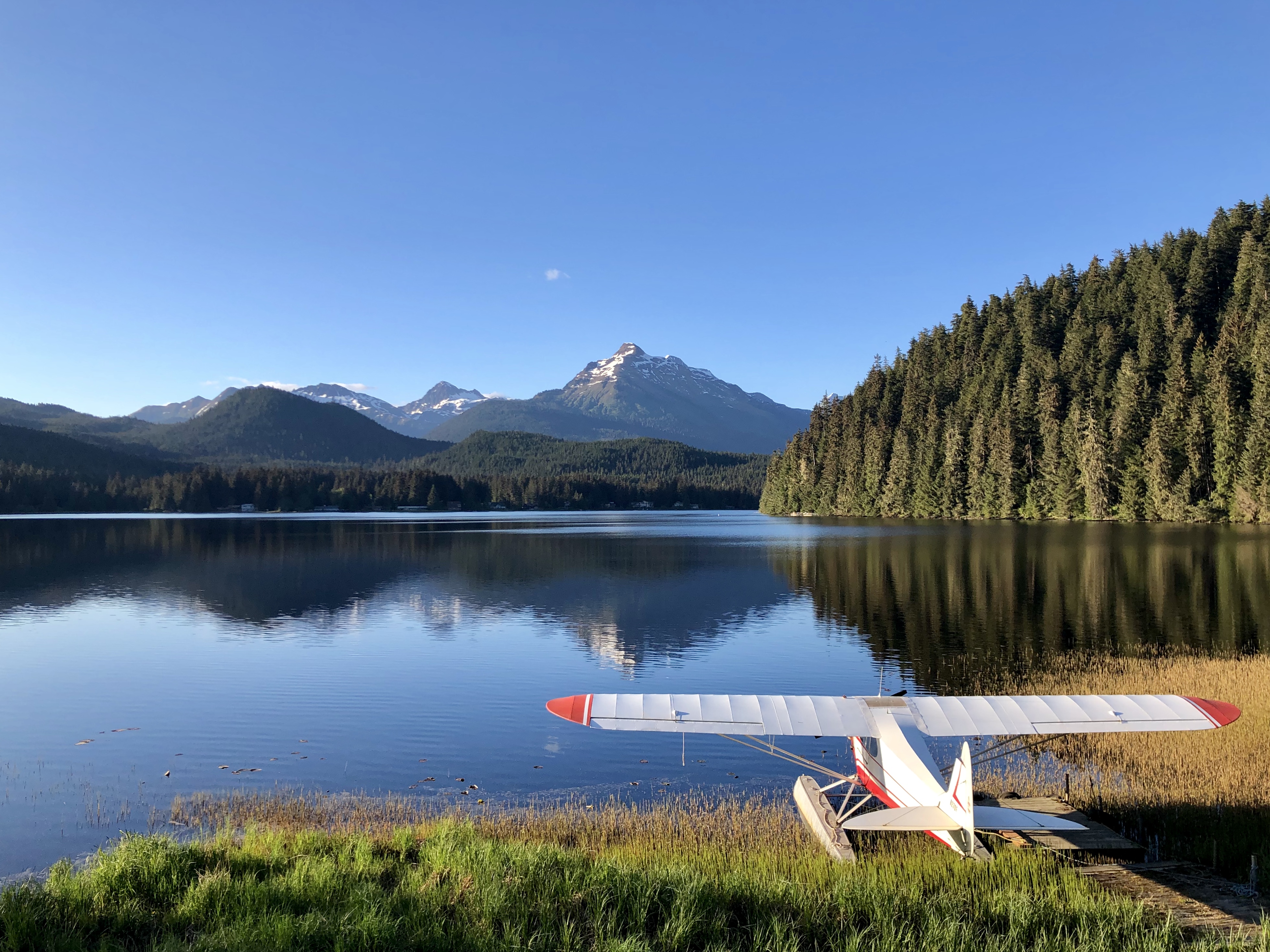 A float plane docked at Auke Lake on a sunny day.