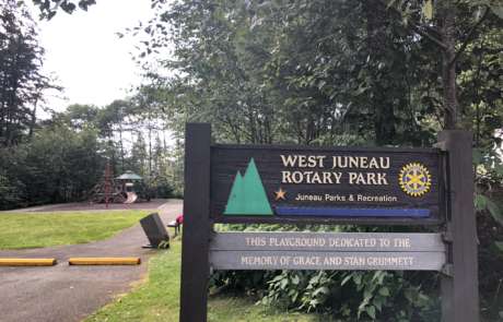 West Juneau Park sign with the playground in the background.