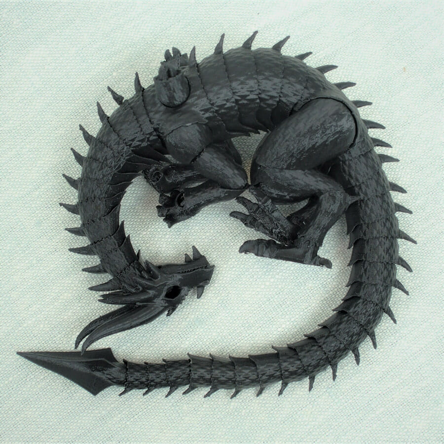 An articulated (ball-jointed) dragon, curled around itself into a circle.