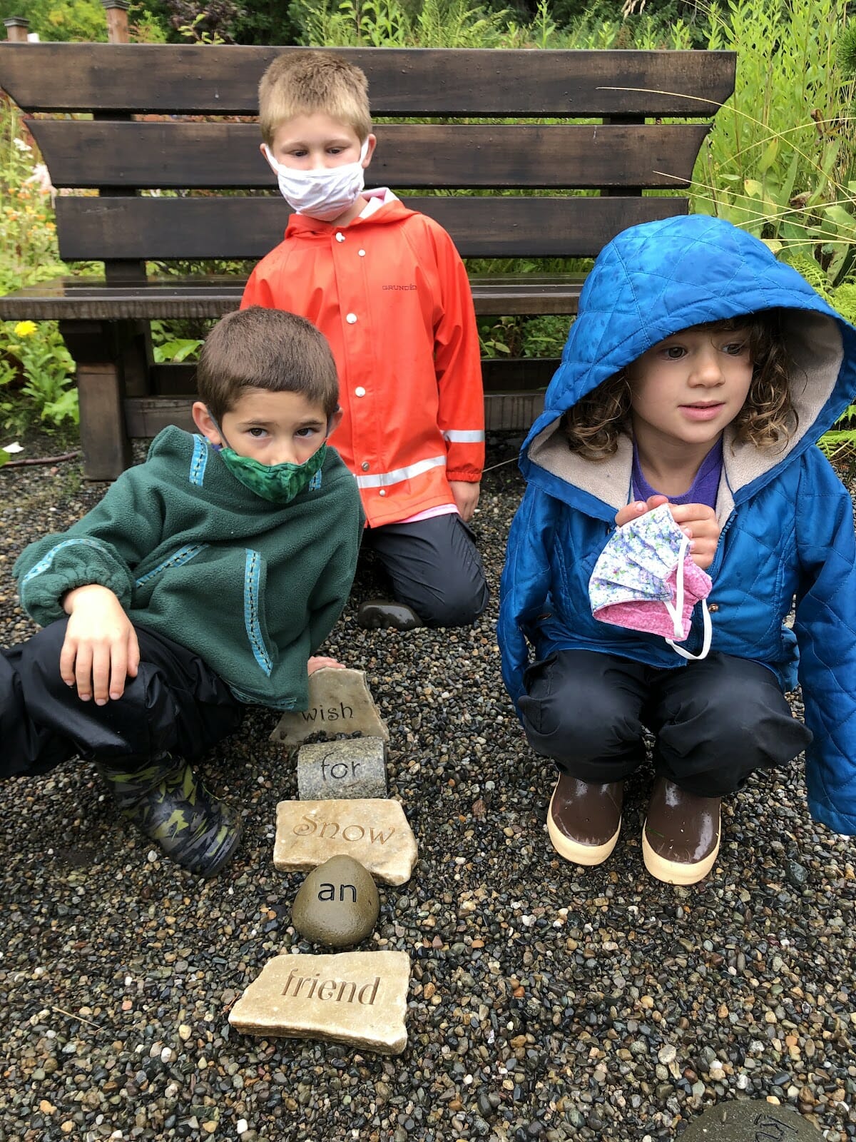 Three kids arranged a phrase in the Word Garden at the Jensen-Olson Arboretum