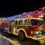 Photo of fire truck decorated with holiday lights