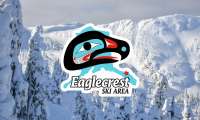 Eaglecrest logo superimposed over a backdrop of snowy mountains