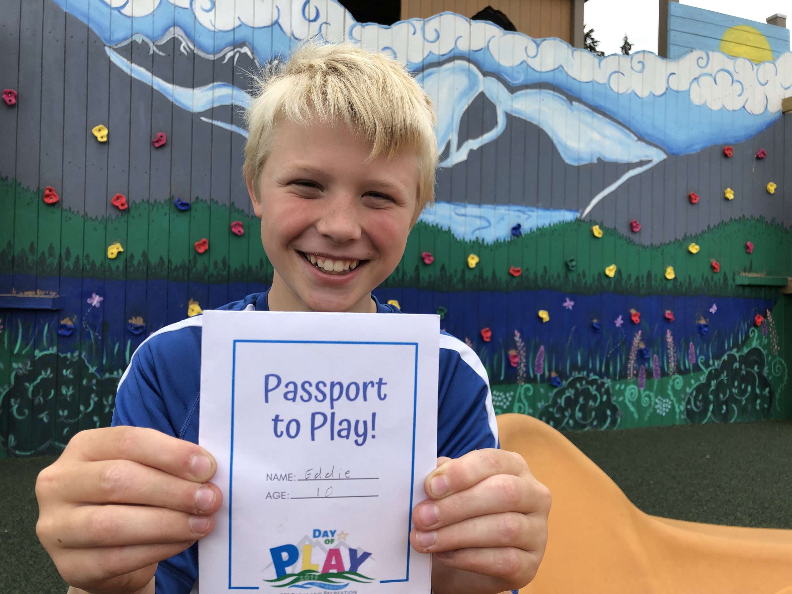 Elliott holding up Passport to Play