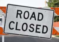 Photo of a sign reading Road Closed