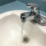 A photo of a tap running water in a sink