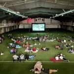 Photo of children watching a movie inside the Field House