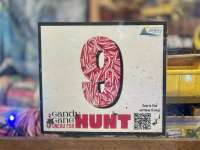 Photo of with candy-cane patterned sign of the number 9 and Candy Cane Hunt logo