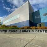 Photo of metallic building exterior with sign reading Dimond Park Aquatic Center
