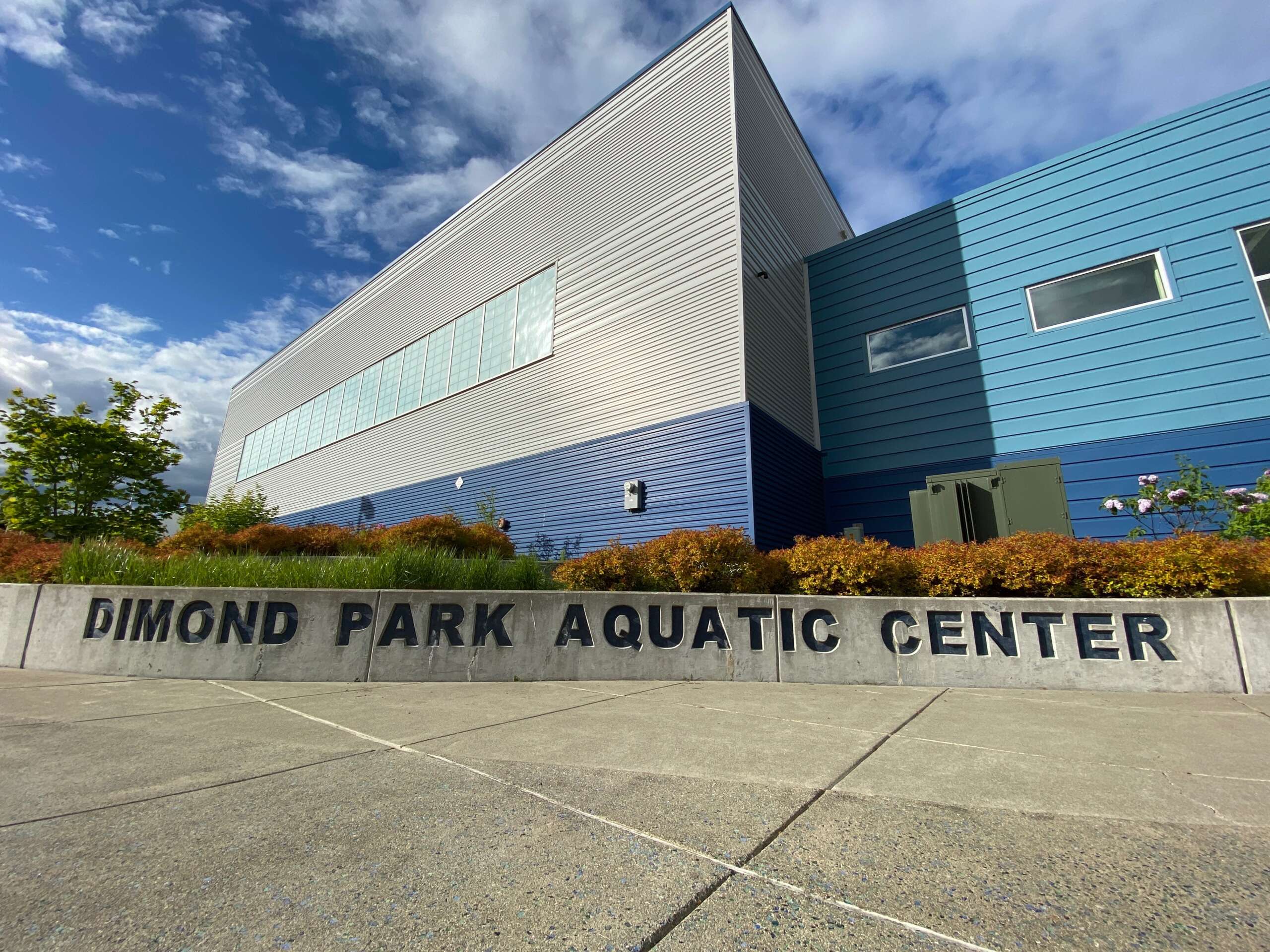 Photo of metallic building exterior with sign reading Dimond Park Aquatic Center