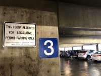 Photo of parking garage with sign posted reading 