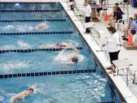 Photo of swimmer kick turning against a pool wall