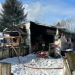 Photo of mobile home with significant burn damage