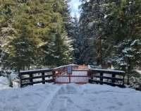 Photo of Montana Creek bridge in heavy snow closed off by barrier