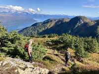 Photo of hiker walking over mountains