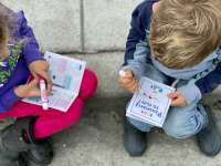 Photo of two young children filling out Passport to Play booklets
