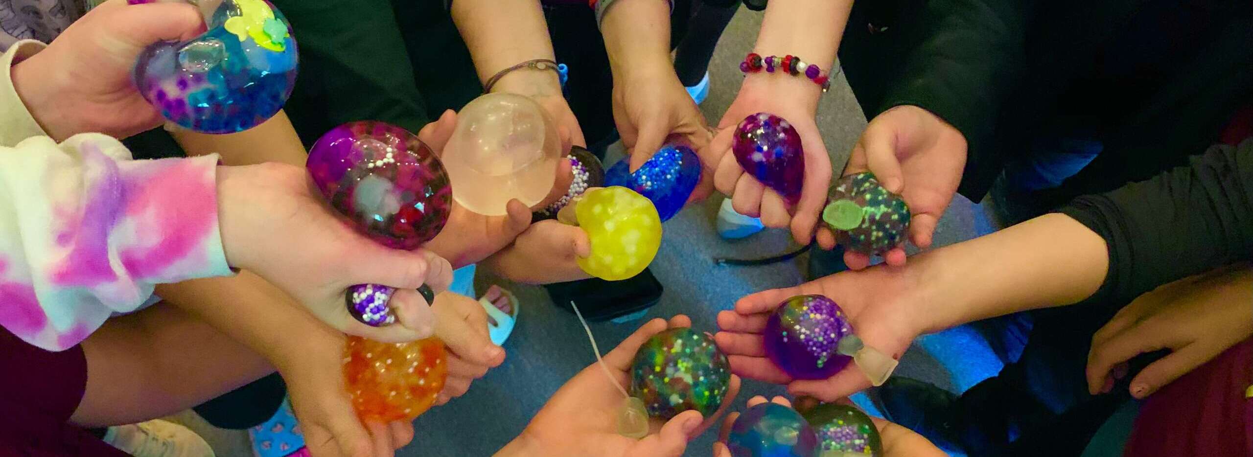 Children holding hand-made stress balls at an afterschool program