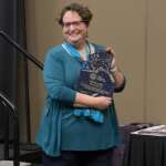 Photo of Beth McEwen holding AAMC Clerk of the Year award