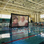 Photo of giant movie screen floating in swimming pool