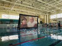 Photo of giant movie screen floating in swimming pool