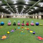 Photo of children's play equipment laid out on the Field House turf