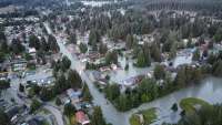 Aerial photo of neighborhood streets flooded with river water.