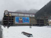 View of Marine Parking Garage on the Elizabeth Peratrovich mural side with the plaza covered in snow