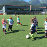 Young children chase a soccer ball on the Juneau-Douglas High School turf