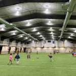 Children playing on indoor turf field