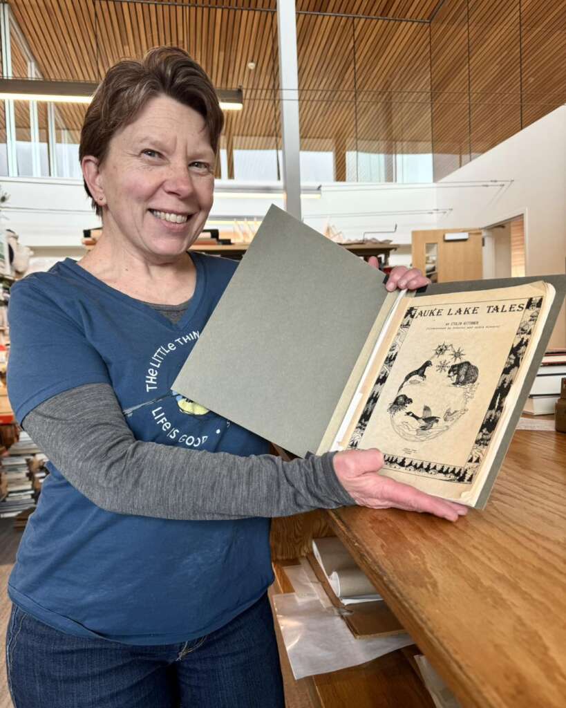 webpic1 Library staff holding open a book