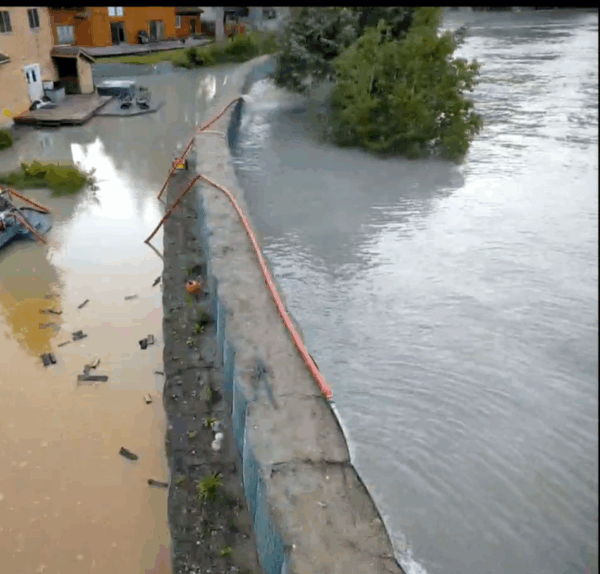 20250813 Drone screenshot 8 drone footage of a river, flood barriers and backyard with water pumps