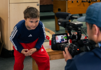 A student at the Zach Gordon Youth Center looks into the camera while being filmed in summer 2025.