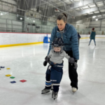 IR Photo - Parent Tot Ice A woman helps a small boy ice skate at Treadwell Arena.