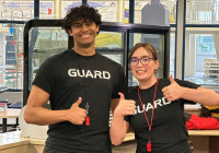 Two Juneau Pools lifeguards pose with thumbs up at the Dimond Park Aquatic Center.