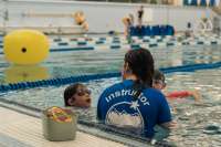 A water instructor teaches kids how to swim at the Dimond Park Aquatic Center. 