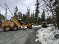 A CBJ Streets & Fleets worker uses a large truck to spread material into a pothole on Cohen Drive.
