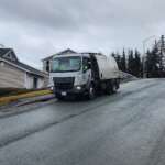 Street maintenance vehicle cleaning roadway in Juneau, Alaska.