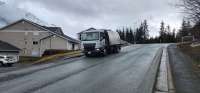 Street maintenance vehicle cleaning roadway in Juneau, Alaska.