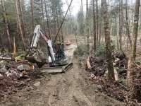 A tractor lifts debris from a trail for construction of the 35-mile ORV riding park.